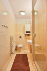 y baño con ducha, aseo y lavamanos. en Apartamenty Świnoujście - Casa Marina en Świnoujście