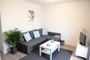 a living room with a couch and a table at Alpenparadies in Reit im Winkl