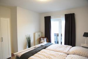 a bedroom with a large bed and a window at Alpenparadies in Reit im Winkl