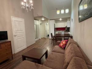 a living room with a couch and a table at Rauhan Marinella Apartments in Imatra