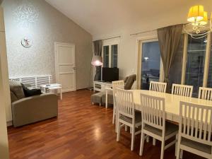 a living room with a table and chairs and a couch at Rauhan Marinella Apartments in Imatra +11 photos
