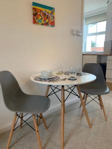 a table and two chairs in a room at Coastal Corner in Mundesley