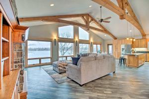 a living room with two couches and a kitchen at Luxe Lake Latoka Home with Dock, Hot Tub and Game Room in Alexandria
