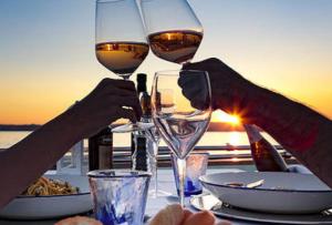 two people are holding glasses of wine on a table at BED&BOAT II boatandholiday com in Fano