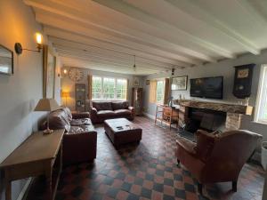a living room with a couch and a fireplace at Common Farmhouse in Newark-on-Trent