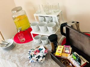 a table with a tray of coffee cups and juice at Domowe Zalesie in Piaseczno