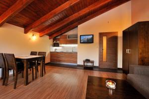 a living room with a table and a couch at Villa Gardenia in Donovaly