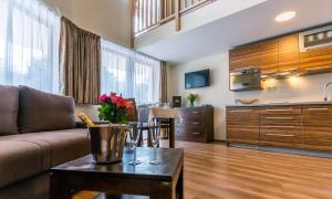 a living room with a couch and a table at Villa Gardenia in Donovaly +45 photos