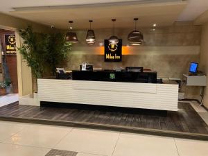a lobby with a reception desk in a mall at Miles Inn Hotel in Hassan