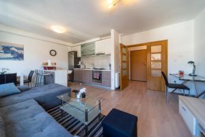 a living room with a couch and a table at SUPER PetrovA Apartment in Zagreb