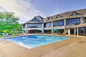 a swimming pool in front of a large building at Stonebridge Resort Condo Near Silver Dollar City! in Branson West