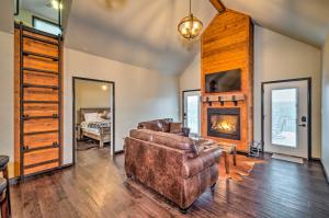 a living room with a couch and a fireplace at Tranquility Lake Getaway with Hot Tub on 27 Acres! in Columbia