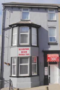 a building with a sign on the front of it at Blackpool Beach Holiday Flats in Blackpool