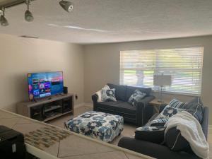 a living room with a couch and a tv at Hidden quiet gem close to everything!!! in Sarasota