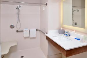 a bathroom with a sink and a shower at Holiday Inn Express Hotel & Suites Cincinnati - Mason, an IHG Hotel in Mason