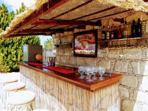 a bar with wine glasses on a stone wall at Villa Asteri, views, private, pool heating on request, 30 mins from Paphos in Paphos