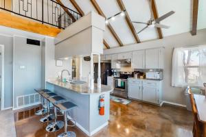 a kitchen with white cabinets and a counter with stools at Deer Ridge in Canyon Lake