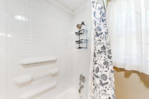 a bathroom with a shower curtain and a window at Deer Ridge in Canyon Lake +13 photos