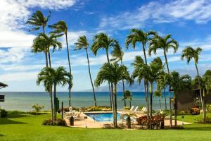 a view of the ocean from a resort with palm trees at Mahina Surf in Kahana