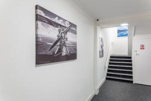 a hallway with a painting on the wall and a staircase at Darlington Town Centre Apartments free parking and Wi-Fi in Darlington