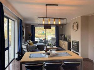 a kitchen and living room with a table and chairs at Enjoy Durbuy 2 in Durbuy
