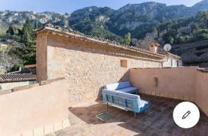 a blue couch sitting on a patio on a building at Font Fresca House ETV 84817 in Deia