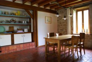 Odiel & Gabrielle في Montchevrier: مطبخ وغرفة طعام مع طاولة وكراسي