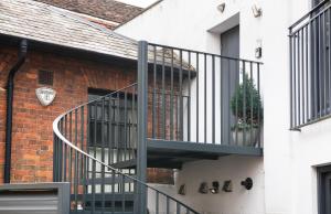 a spiral staircase on the side of a brick building at My Unique Place - St Peters Mews in St. Albans