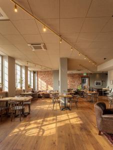 a restaurant with tables and chairs and a brick wall at Nybro Stora Hotellet in Nybro
