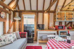 a living room with a couch and a table at The Granary by Bloom Stays in Canterbury