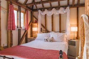 a bedroom with a bed with a teddy bear on it at The Granary by Bloom Stays in Canterbury