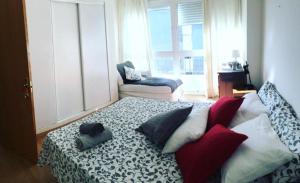 ein Zimmer mit einem Bett mit Kissen darauf in der Unterkunft La Brisa Malagueta in Málaga