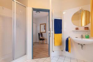 a bathroom with a shower and a sink at Ferienwohnung #3 Am Neuensiener See - Seedorf in Sellin