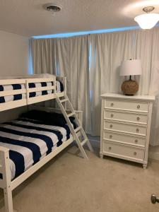 a bedroom with a bunk bed and a dresser at Private heated pool , resort style home , minutes from the beach in Deerfield Beach +42 photos