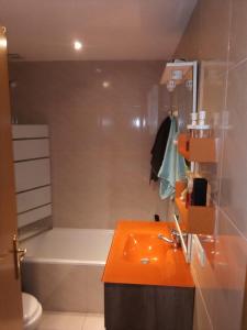 ein Badezimmer mit einem orangenen Waschbecken und einer Badewanne in der Unterkunft La Brisa Malagueta in Málaga