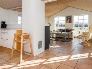 a kitchen and living room with a table and chairs at Four-Bedroom Holiday home in Ulfborg 9 in Øby