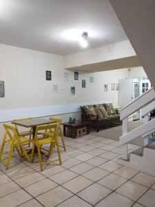a living room with a table and a couch at Pousada Mananauê Beach in Porto De Galinhas