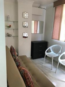 a living room with a couch and a chair at Apartamentos Amoblados JG de la 70 in Medellín