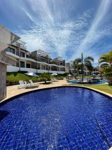 a large swimming pool in front of a resort at Casa Pipa Charme do Amor in Pipa