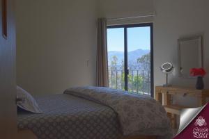 A bed or beds in a room at Casa Corazon de Plata Suites