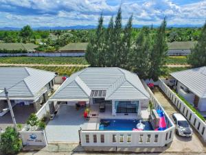 an aerial view of a house with a swimming pool at บ้านซีซ่าเฮ้าส์พูลวิลล่าหัวหิน in Hua Hin