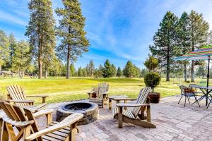 a patio with chairs and an umbrella and a fire pit at Bend Country Club Golf Course Beauty in Bend
