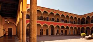 a courtyard of a building with columns at Casa La Marina in Los Mochis