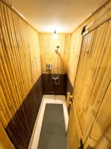 a wooden bathroom with a shower and a toilet at Coconut Island Carita - CHSE Certified in Carita