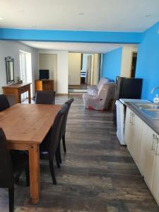 a kitchen and dining room with a wooden table and chairs at gite de l'ornain in Fains-les-Sources