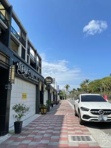 a white car parked on the side of a street at Qing Man Tong Meng Homestay in Hualien City