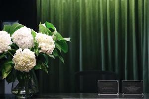 a vase filled with white flowers sitting on a table at Hotel Collins in Melbourne