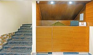 a stairway with a wooden door and a staircase with a laptop at Treebo Trend Dev With Valley View, Mall Road in Manāli