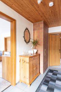 a room with a wooden door and a cabinet with a mirror at Chalet Taurachblick in Tamsweg