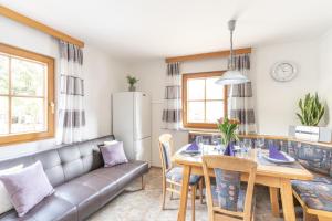 a living room with a table and a couch at Chalet Taurachblick in Tamsweg